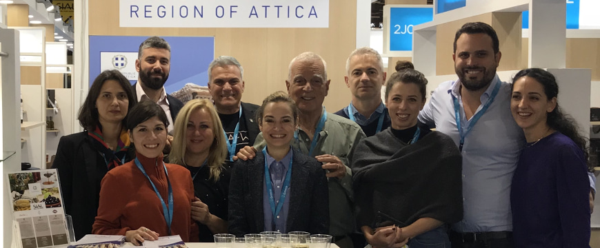 A group of people posing in the Greek Region of Attica booth at SIAL Paris
