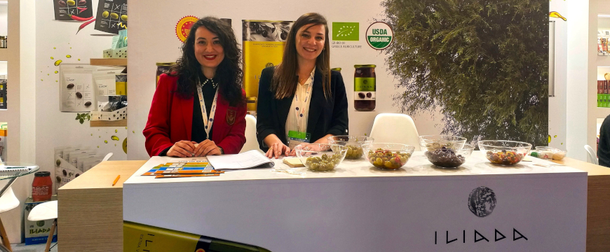 the AGROVIM stand at the Food Expo, with two young women behind the counter