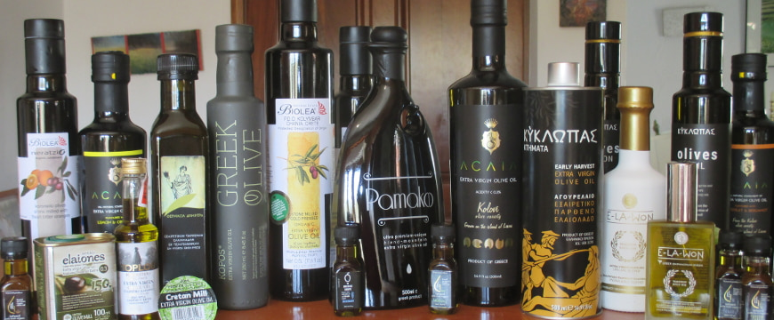 a variety of bottles of Greek olive oil lined up on a countertop