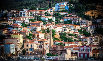 colorful houses on a hillside in the village of Plomari, Lesvos