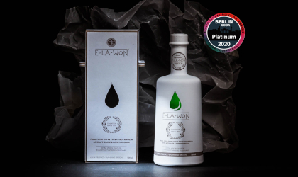 a white bottle and box of Super Premium Elawon with an image of its Platinum award from the Berlin competition