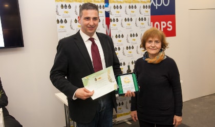 Evge company representative accepting a gold award
