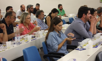 Audience members tasting olive oil at a seminar in Chania, Crete