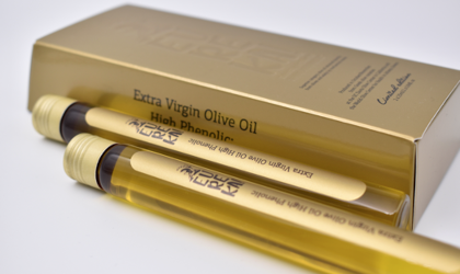 2 vials of Eureka olive oil next to a gold box