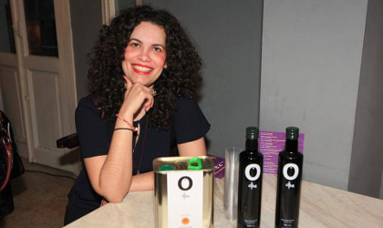 Irini Kokolaki with a tin and two bottles of O Olive olive oil