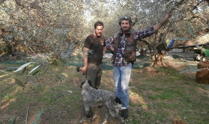 Kyriakos Makratzis, his son, and their dog in their olive grove in Crete