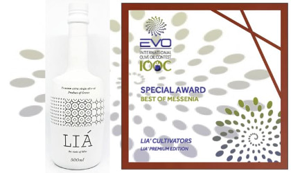A white LIA olive oil bottle next to its Best in Messenia award certificate