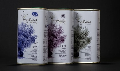 three tins of Mythocia olive oil with olive tree drawings on them