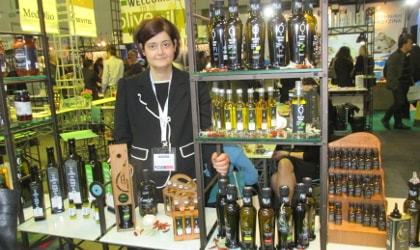 the Pellas Nature stand at the Food Expo in 2017, with Ioanna Diamanti and many small and medium sized bottles of infused olive oil 