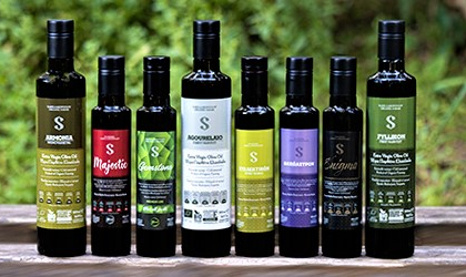 Bottles of Sakellaropoulos Organic Farming olive oils lined up in a row