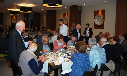 people eating and talking at the World Olive Day event in Grecotel's restaurant