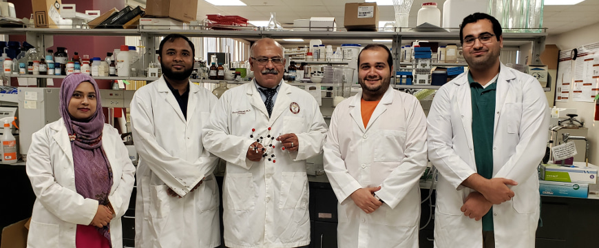 Dr. Khalid El Sayed (center) with his research group in his lab
