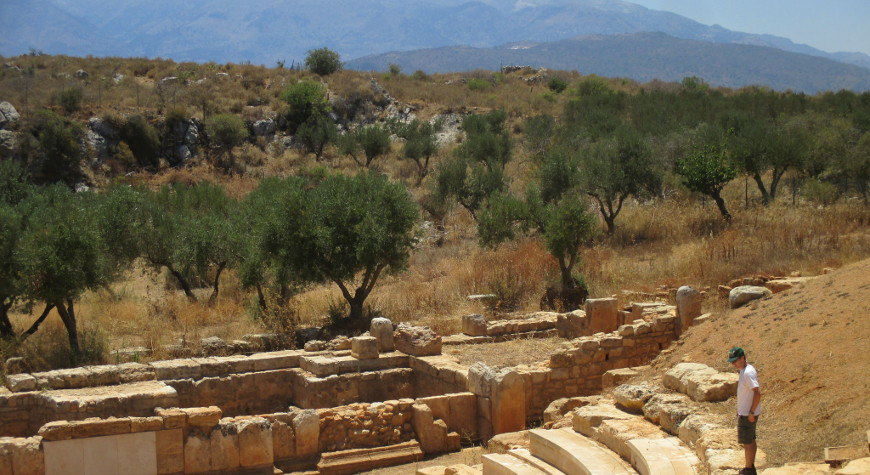 Ancient Aptera's Roman theater with olive groves behind it