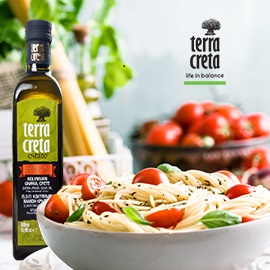 Terra Creta olive oil company's banner ad, showing a bottle of its extra virgin olive oil on the left and a white bowl of pasta with small tomatoes and basil on the right, below the Terra Creta logo