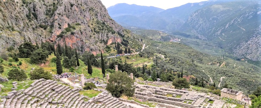 Part of the archaeological site of Delphi, with olive groves in the valley below it