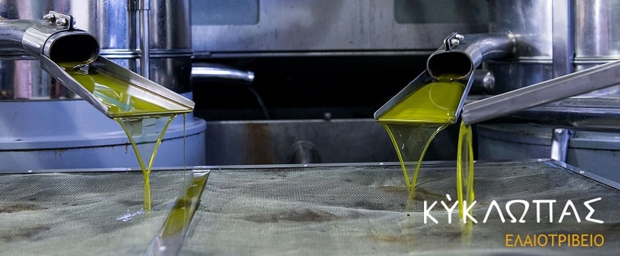 olive oil running out of pipes and through a screen at the Kyklopas olive mill