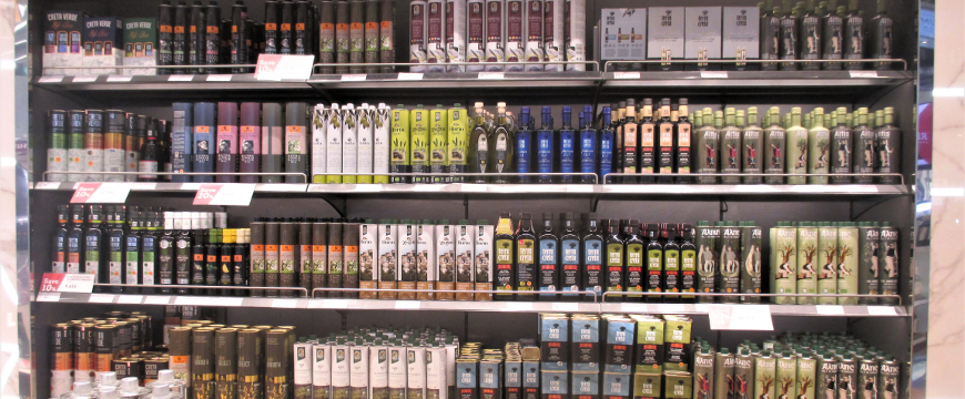 bottles of Greek olive oil on shelves in a shop