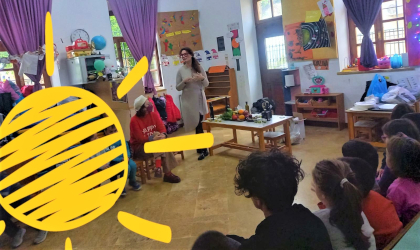 Irini addressing kindergarten children in their classroom