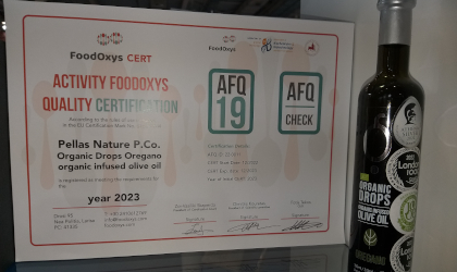 a FoodOxys certificate next to a bottle of Pellas Nature oregano infused olive oil
