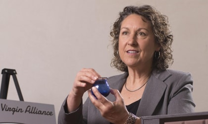 Alexandra Devarenne holding a blue olive oil tasting glass