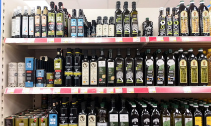 bottles of Greek extra virgin olive oil on supermarket shelves