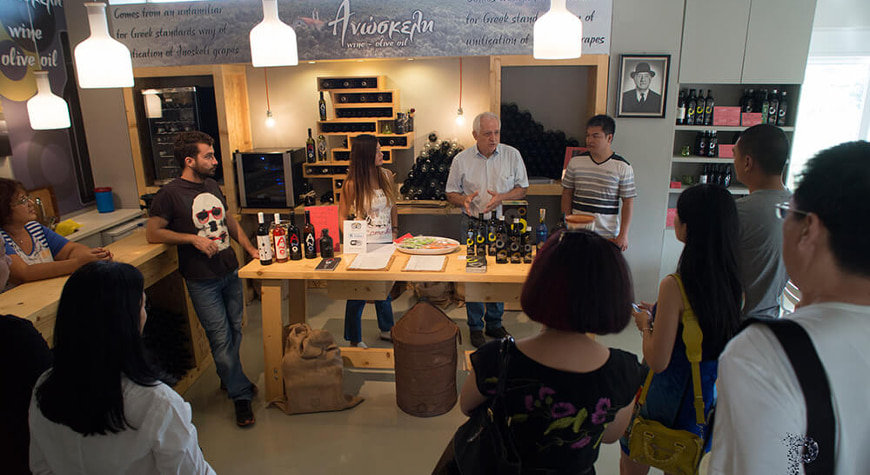 visitors in Anoskeli's olive oil and wine tasting room