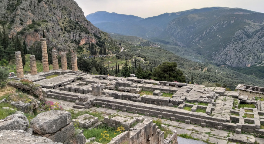 Remains of one of the ancient temples at Delphi, with mountains in the background