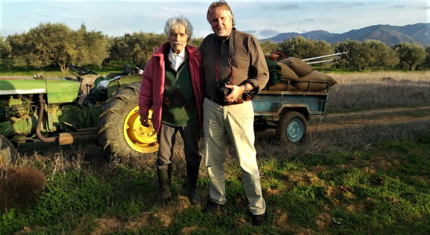 Eduardo Mencos Valdes next to Grigoris Kokolakis by a tractor and a field