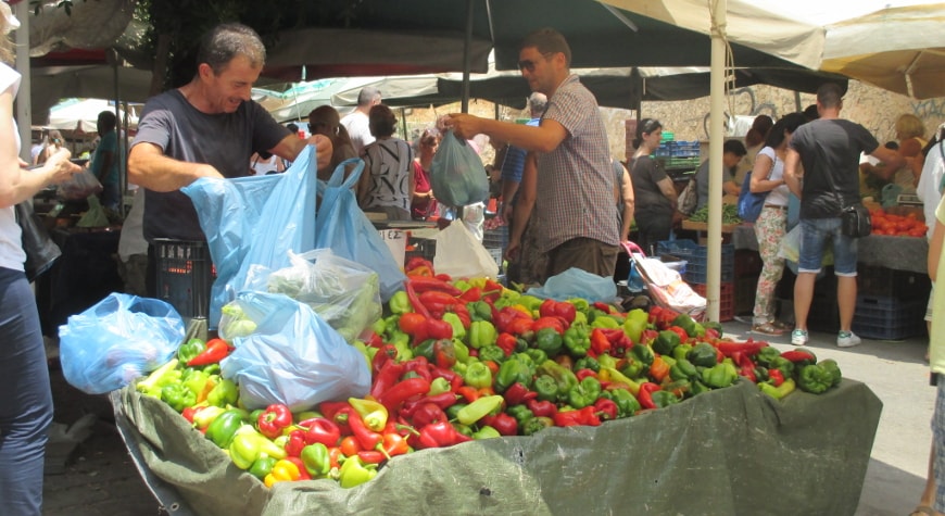 farmers' market with colorful peppers for sale