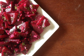 Salad made of chunks of red beets on a white plate