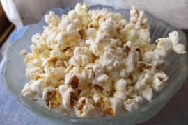 a glass bowl of popcorn