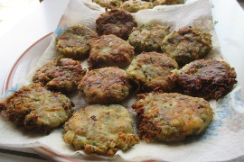 zucchini patties on a paper towel on a plate